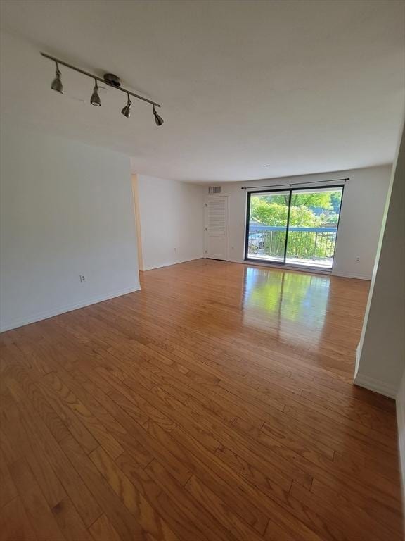 22 Railroad St Unit 115, Andover, MA 01810 - spare room with track lighting, light wood-style flooring, and baseboards