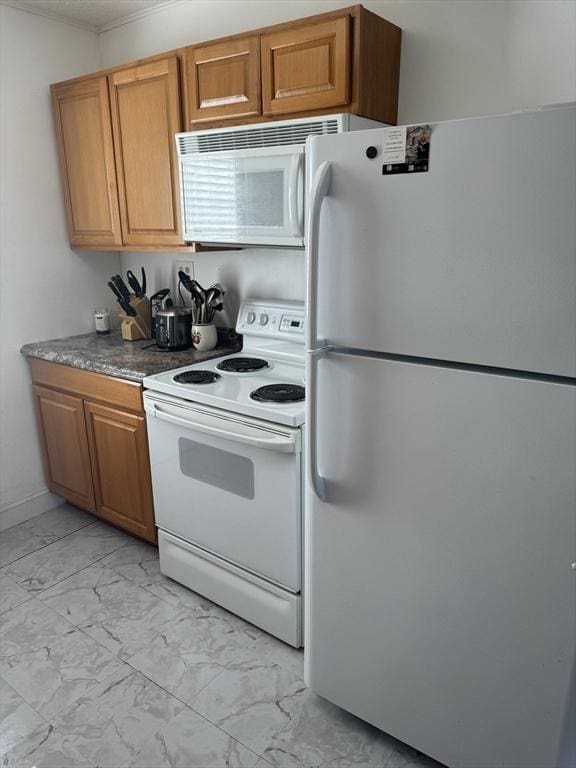 kitchen featuring white appliances, brown cabinets, and marble finish floor