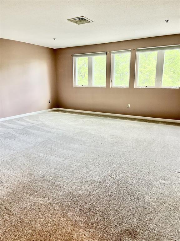 38 Dunham Rd Unit 303, Beverly, MA 01915 - carpeted empty room with baseboards