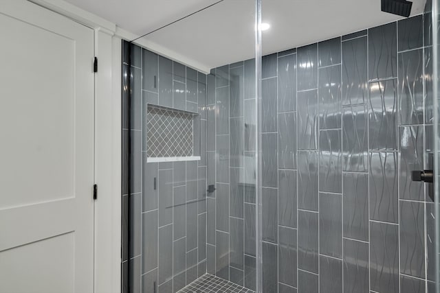 bathroom with a tile shower