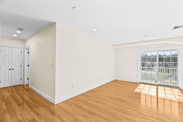 unfurnished room with light wood-type flooring