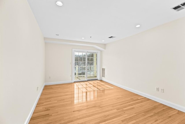 empty room with light hardwood / wood-style flooring