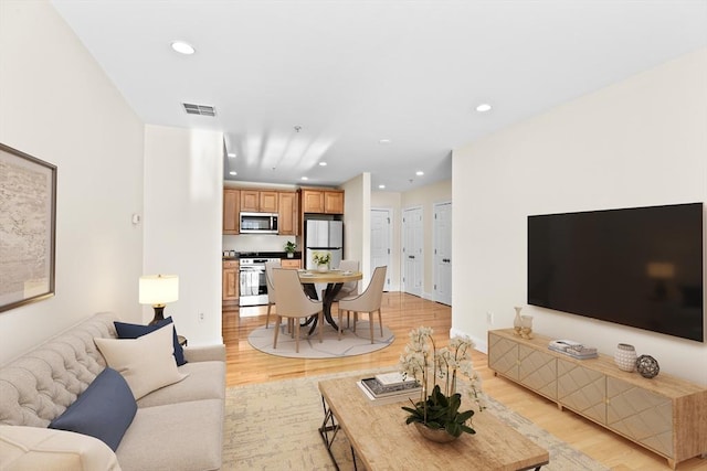 living room with light hardwood / wood-style flooring