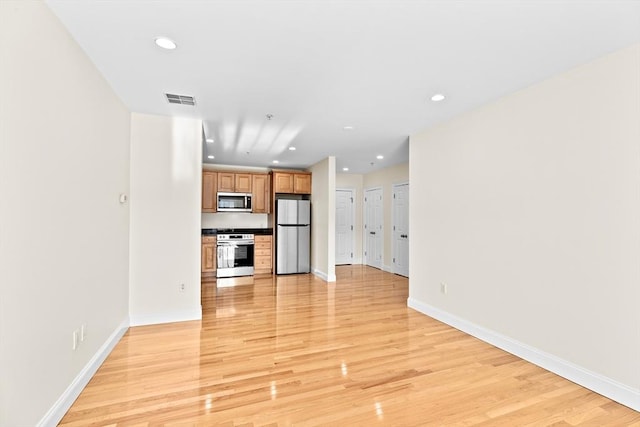 unfurnished living room with light wood-type flooring