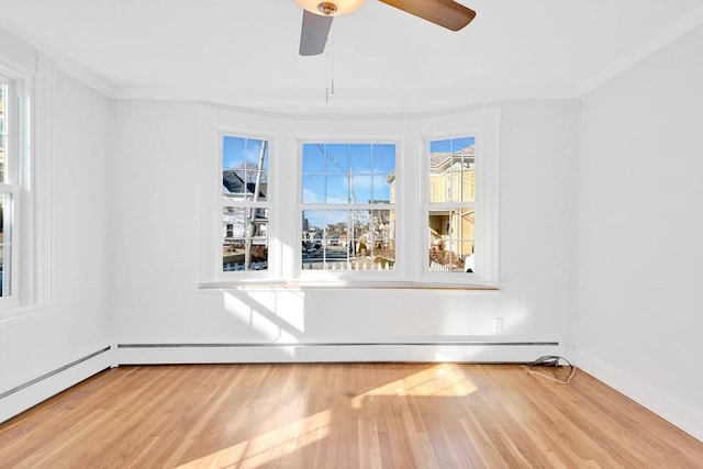 unfurnished room featuring baseboard heating, ceiling fan, ornamental molding, and light hardwood / wood-style flooring