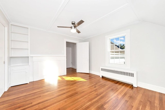 interior space featuring ceiling fan, wood-type flooring, radiator, and ornamental molding