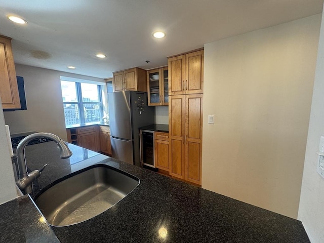 170 Tremont St Unit 1604, Boston, MA 02111 - kitchen featuring wine cooler, a sink, freestanding refrigerator, brown cabinetry, and glass insert cabinets