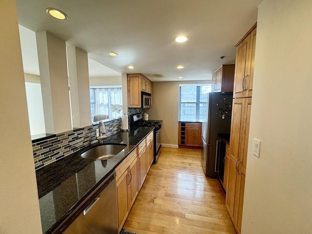 170 Tremont St Unit 1604, Boston, MA 02111 - kitchen with stainless steel appliances, a sink, light wood-type flooring, backsplash, and recessed lighting