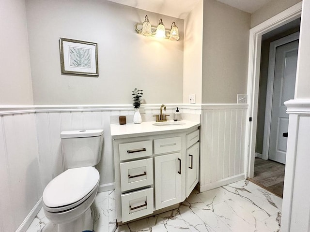 31 Horton St, Attleboro, MA 02703 - half bath featuring marble finish flooring, a wainscoted wall, toilet, and vanity
