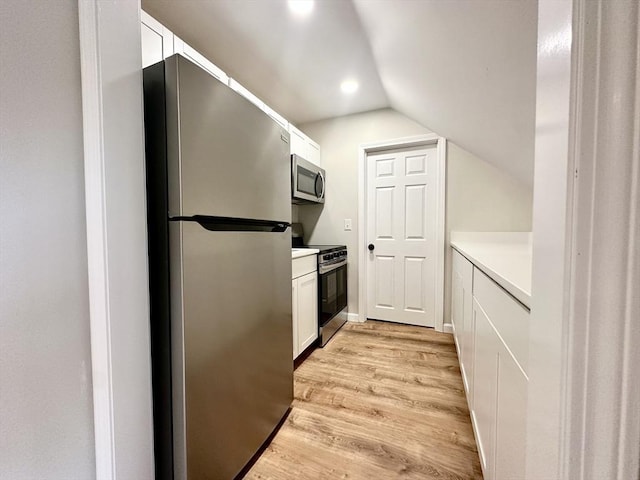 31 Horton St, Attleboro, MA 02703 - kitchen with appliances with stainless steel finishes, white cabinets, light wood-style flooring, lofted ceiling, and light countertops