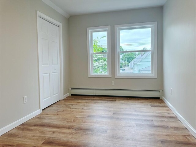 31 Horton St, Attleboro, MA 02703 - unfurnished bedroom with wood finished floors, baseboards, and a baseboard radiator