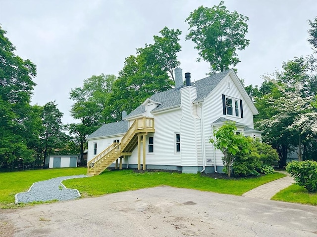 31 Horton St, Attleboro, MA 02703 - rear view of property featuring a chimney, stairway, a yard, and a shingled roof