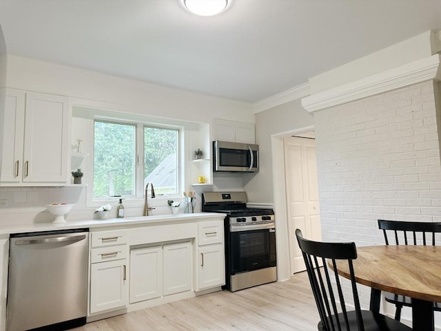 31 Horton St, Attleboro, MA 02703 - kitchen with stainless steel appliances, open shelves, a sink, light wood-style flooring, and white cabinets