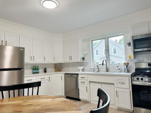 31 Horton St, Attleboro, MA 02703 - kitchen with appliances with stainless steel finishes, open shelves, light countertops, and a sink