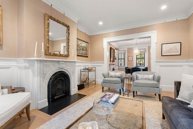 living room with ornamental molding and light hardwood / wood-style flooring