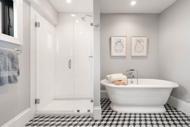 bathroom featuring shower with separate bathtub