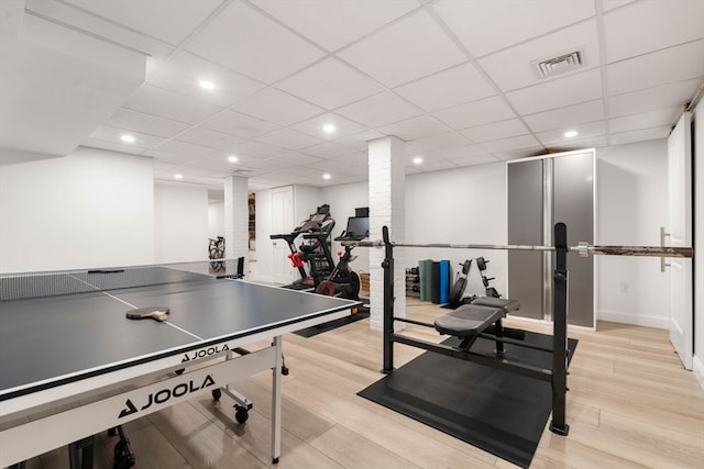 rec room featuring a drop ceiling and light hardwood / wood-style flooring