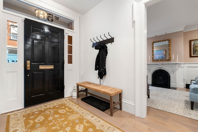 entrance foyer featuring light wood-type flooring and crown molding