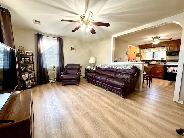 living room with ceiling fan and light hardwood / wood-style floors