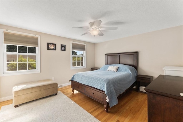112 Cocasset St Unit 3, Foxboro, MA 02035 - bedroom with light wood-type flooring, baseboards, a ceiling fan, and a textured ceiling