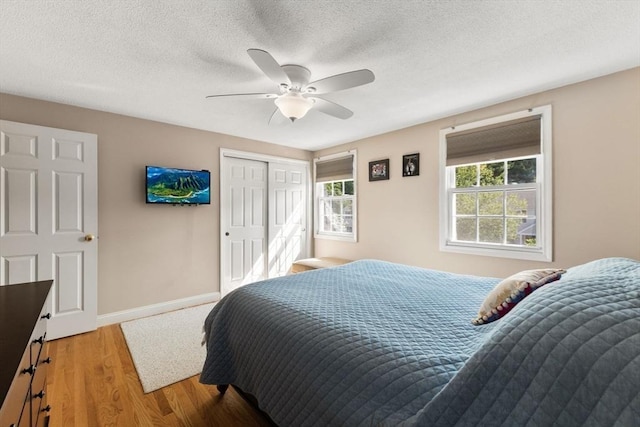 112 Cocasset St Unit 3, Foxboro, MA 02035 - bedroom featuring multiple windows, wood finished floors, a closet, baseboards, and a textured ceiling