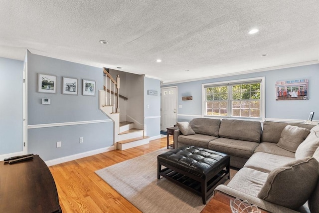 112 Cocasset St Unit 3, Foxboro, MA 02035 - living area with light wood-type flooring, a textured ceiling, stairs, recessed lighting, and crown molding