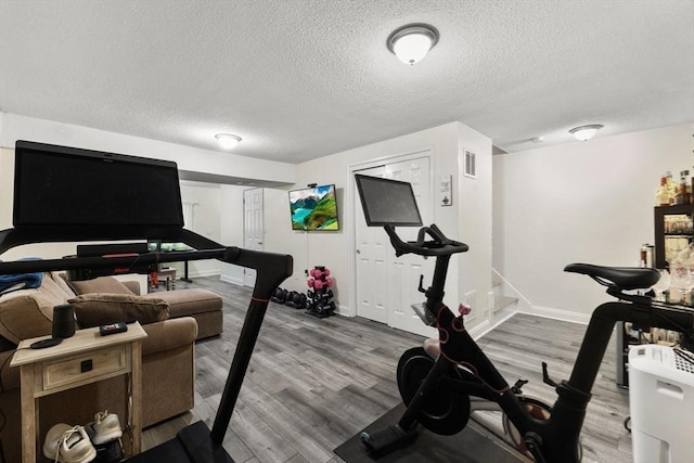 112 Cocasset St Unit 3, Foxboro, MA 02035 - exercise room with a textured ceiling, baseboards, and wood finished floors