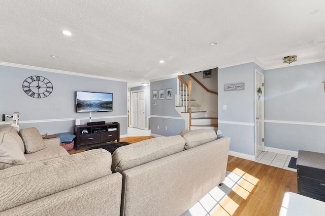 112 Cocasset St Unit 3, Foxboro, MA 02035 - living area with ornamental molding, stairs, light wood-type flooring, a textured ceiling, and recessed lighting