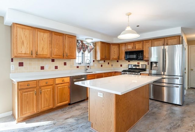 kitchen with backsplash, decorative light fixtures, light countertops, appliances with stainless steel finishes, and a sink