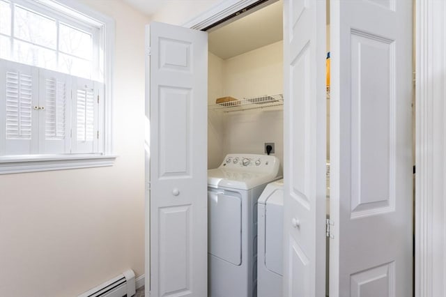 washroom featuring baseboard heating, washing machine and dryer, and laundry area