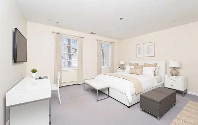 bedroom with visible vents, baseboards, a baseboard heating unit, and carpet