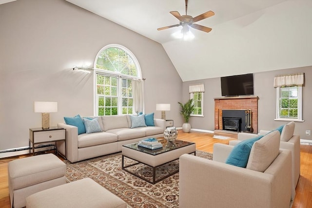 living room featuring baseboards, high vaulted ceiling, a ceiling fan, and wood finished floors