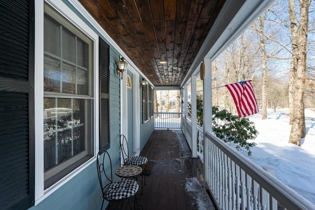 view of snow covered back of property