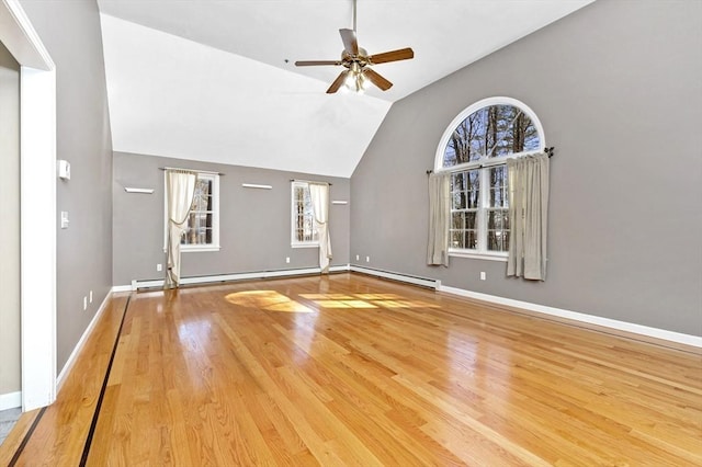 unfurnished living room featuring wood finished floors, baseboards, baseboard heating, and ceiling fan