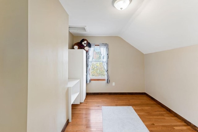 bonus room with light hardwood / wood-style floors and vaulted ceiling