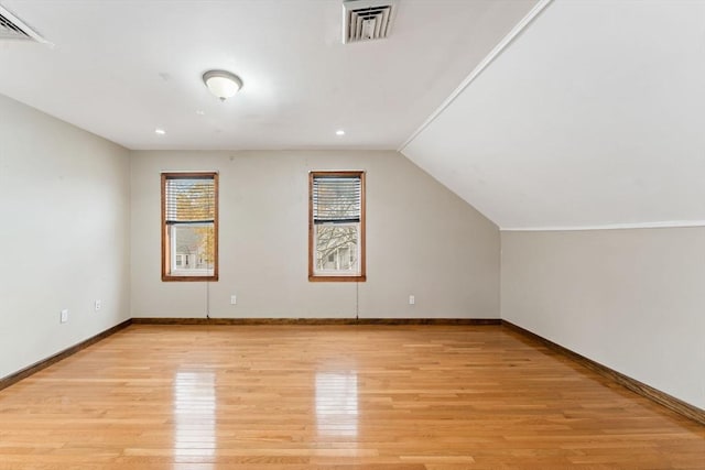 bonus room featuring lofted ceiling and light wood-type flooring