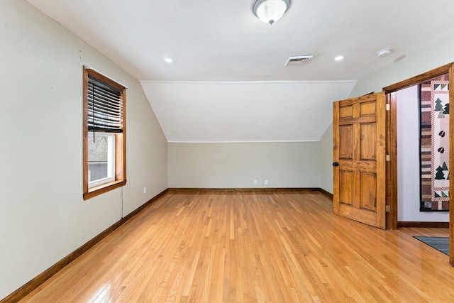 additional living space with lofted ceiling and light hardwood / wood-style floors