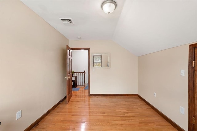 bonus room featuring lofted ceiling and light hardwood / wood-style floors