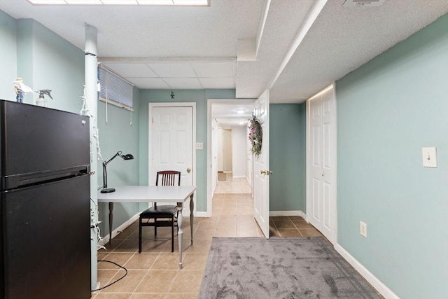 tiled home office with a paneled ceiling