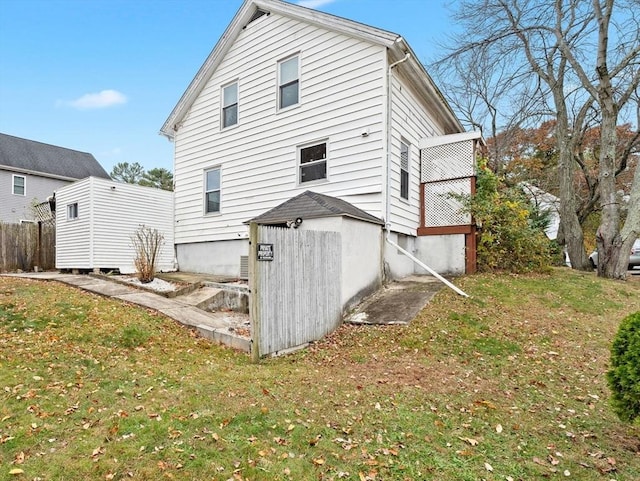 rear view of house featuring a yard