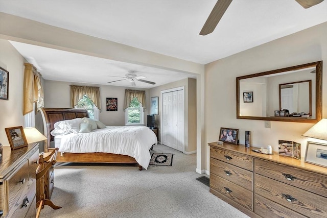 carpeted bedroom featuring ceiling fan and a closet