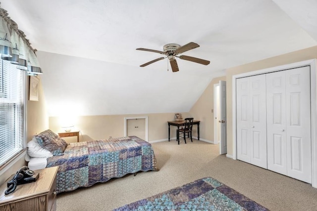 bedroom with a closet, ceiling fan, vaulted ceiling, and carpet floors