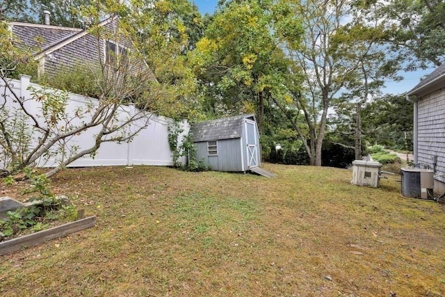 view of yard featuring central air condition unit and a shed