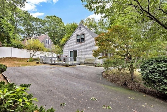 view of property exterior featuring a deck