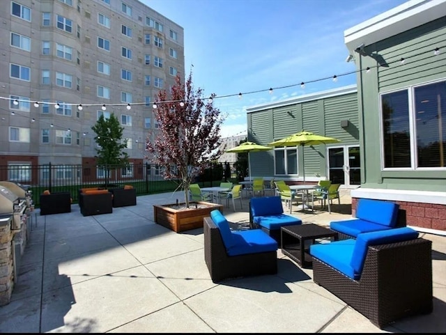 view of patio / terrace featuring outdoor lounge area, fence, and french doors