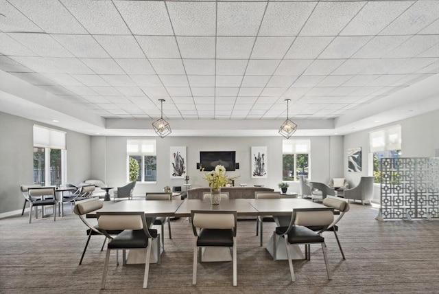 dining area with a tray ceiling, recessed lighting, and baseboards