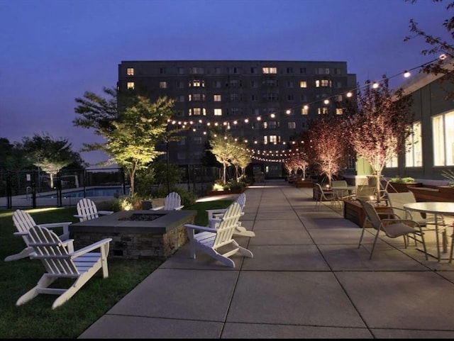 view of property's community featuring an outdoor fire pit and a patio area