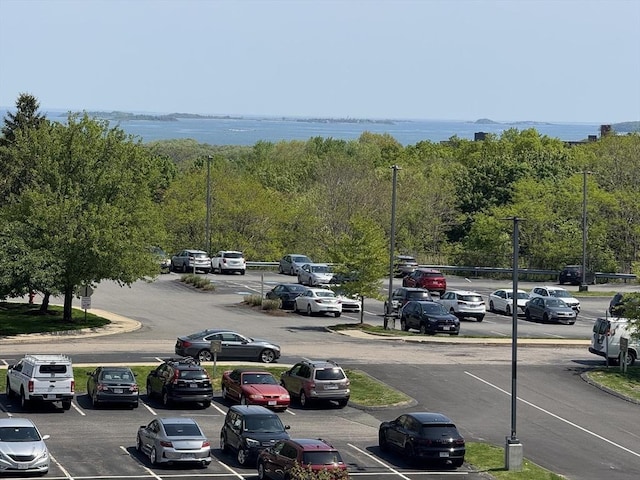 uncovered parking lot with a water view