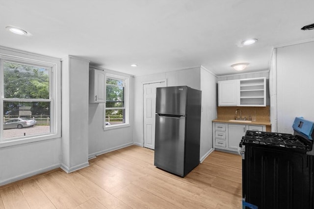 686-688 E Ave, Warwick, RI 02886 - kitchen with stainless steel appliances, open shelves, light wood-type flooring, healthy amount of natural light, and recessed lighting