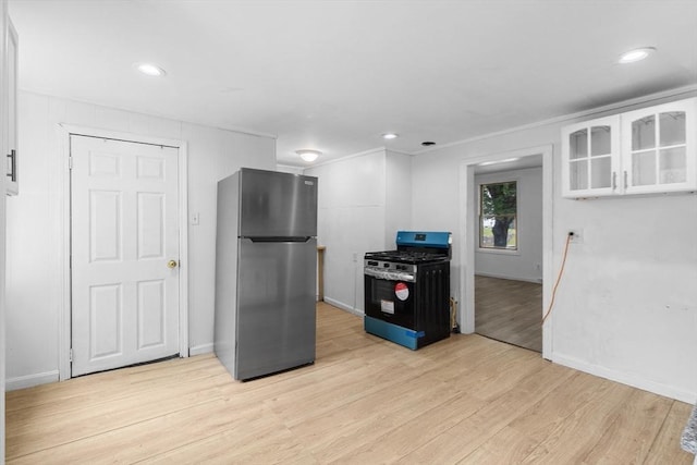 686-688 E Ave, Warwick, RI 02886 - kitchen with freestanding refrigerator, gas range oven, light wood-type flooring, white cabinets, and glass insert cabinets